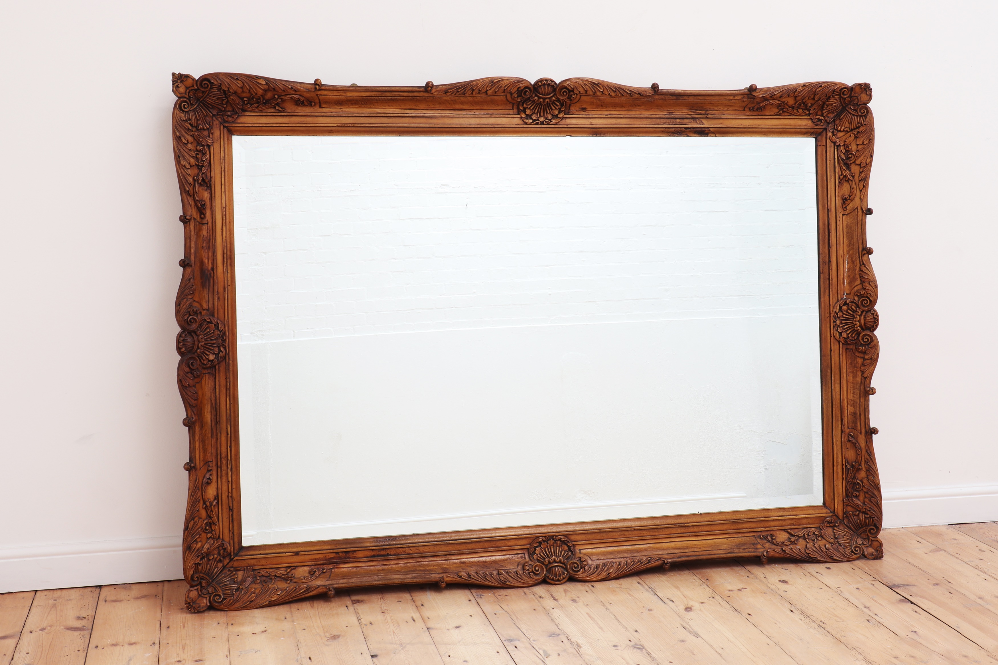 A large carved beech framed mirror